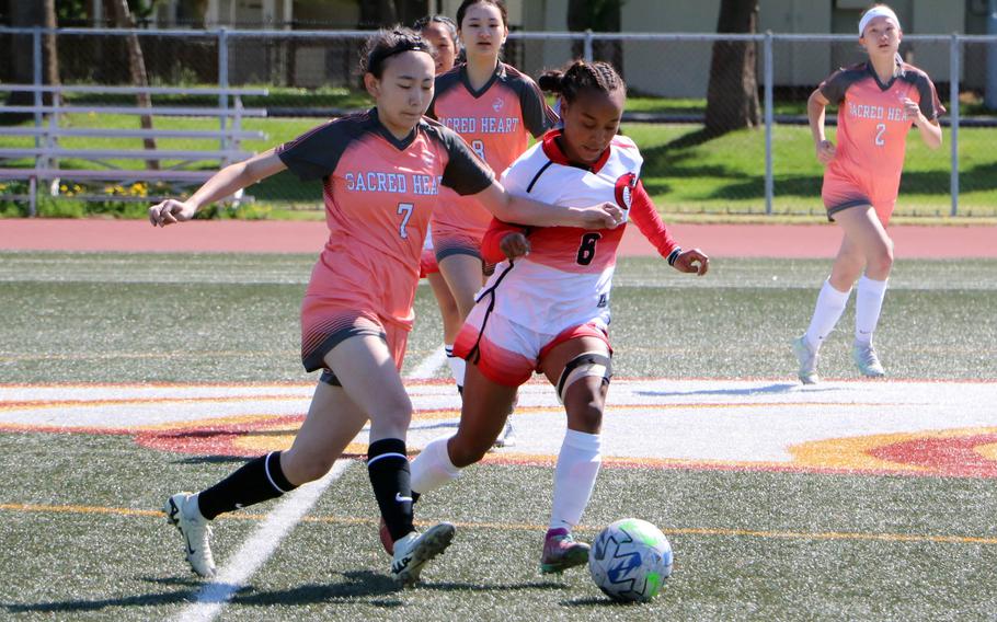 Sacred Heart's Saya Miyawaki and King's Miu Best give chase during Wednesday's third-place Girls Division II soccer match. The Symbas won 5-4.