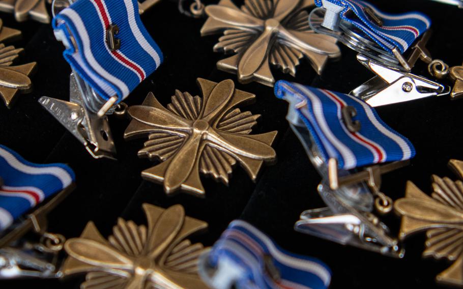 Distinguished Flying Cross medals lie in rows.