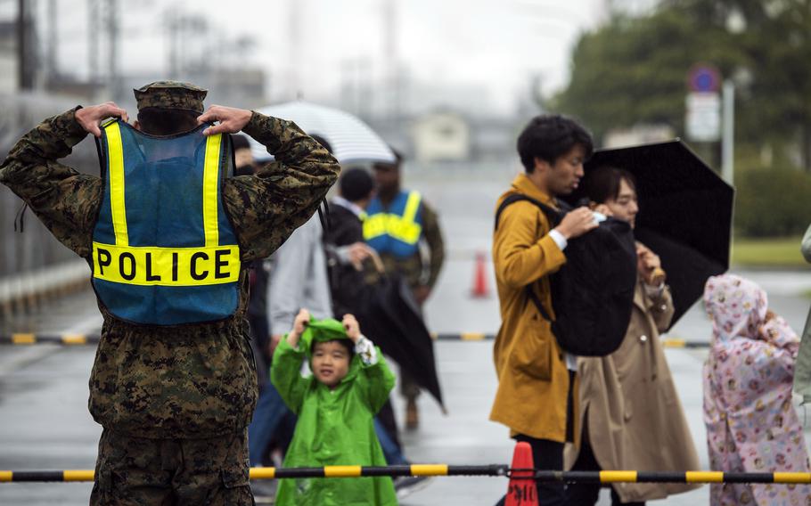 Marine Cpl. Matthew Rivera interacts with a child visiting Marine Corps Air Station Iwakuni, Japan, on Friendship Day, Saturday, April 15, 2023.