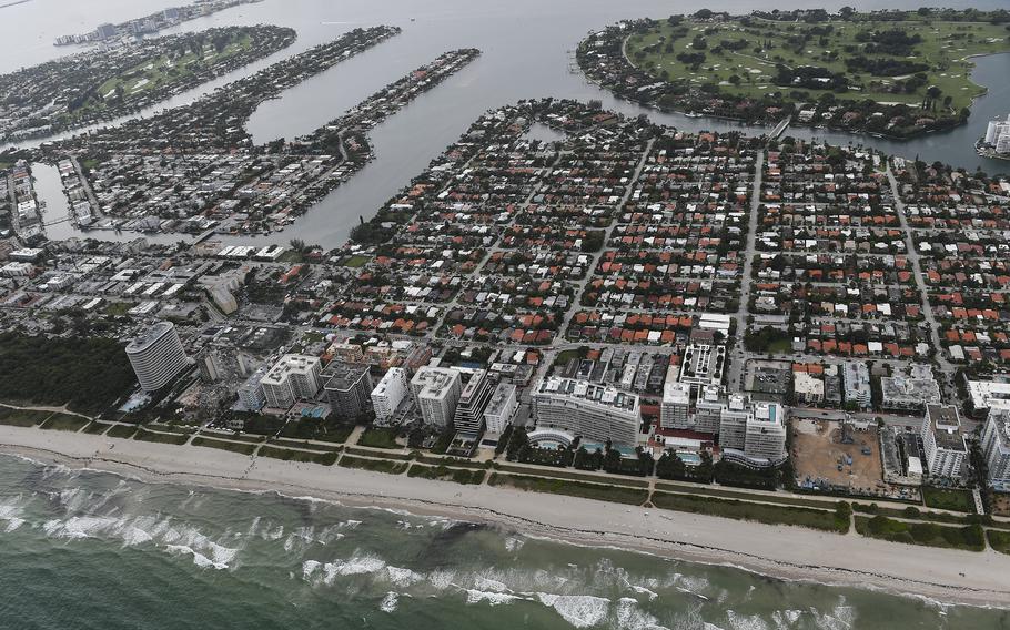 Aerial view of the collapsed Champlain Towers South and the coastline.