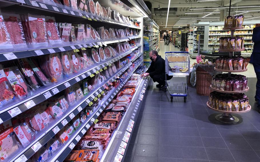 A shopper checks out the meat aisle at an Edeka store near Ramstein Air Base, Germany, on April 4, 2022. Prices for everyday goods and groceries in the country are expected to jump sharply, a trade association is warning.