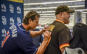 MLB Hall of Famer Trevor Hoffman signs a Padres jersey during a meet-and-greet inside the main exchange at Camp Humphreys, South Korea, March 17, 2024.