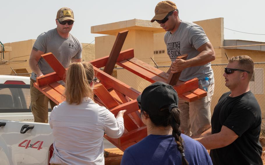 U.S. service members deployed to Camp Lemonnier repaired desks and delivered picnic tables in support of the 450th Civil Affairs Battalion renovation project at a primary school in Ali Oune, Djibouti, June 7, 2023. The 450th Civil Affairs Battalion coordinated with the school to fix the existing desks with new wooden desktops and provide picnic tables for the students.