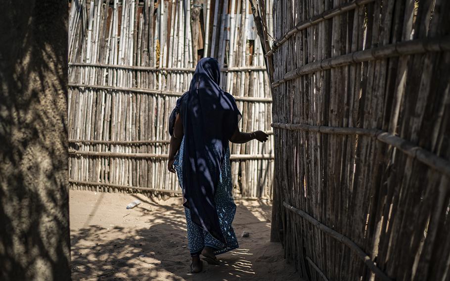 Ulenca, 22, makes her way home in Pemba, Mozambique, on Sept. 1, 2022.