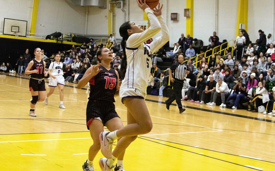Academy of Our Lady's Maria Paulino shoots against Nile C. Kinnick's Leona Turner. Paulino's go-ahead basket helped the Cougars won the ASIJ Kanto Classic girls final 27-19.