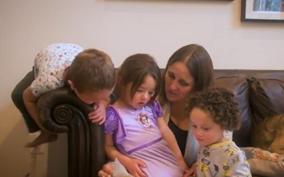 A military family featured in the first episode of the Out of Uniform video series reads a book.