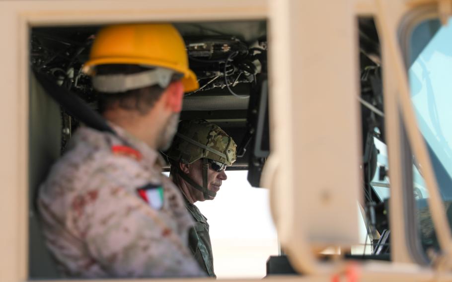 Kuwaiti Col. Fahad Buresli and Lt. Gen. Patrick Frank, commanding general of U.S. Army Central, take a ride during driverless vehicle testing at Camp Buerhing, Kuwait, on July 25, 2023. 