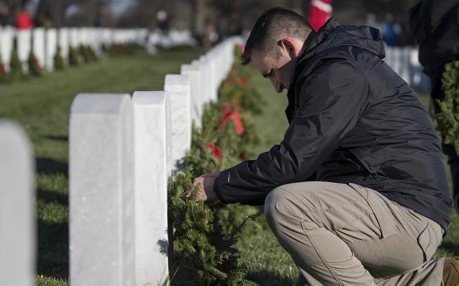 Army Chief Warrant Officer Robert Pritchard  lays a wreath at Arlington National Cemetery on Saturday, Dec. 17, 2022.