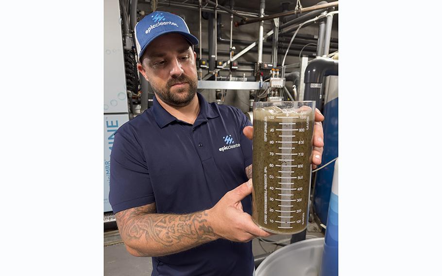 Epic Cleantec operations director Ryan Pulley holds a beaker of treated wastewater, known as gray water, from a San Francisco apartment tower. 