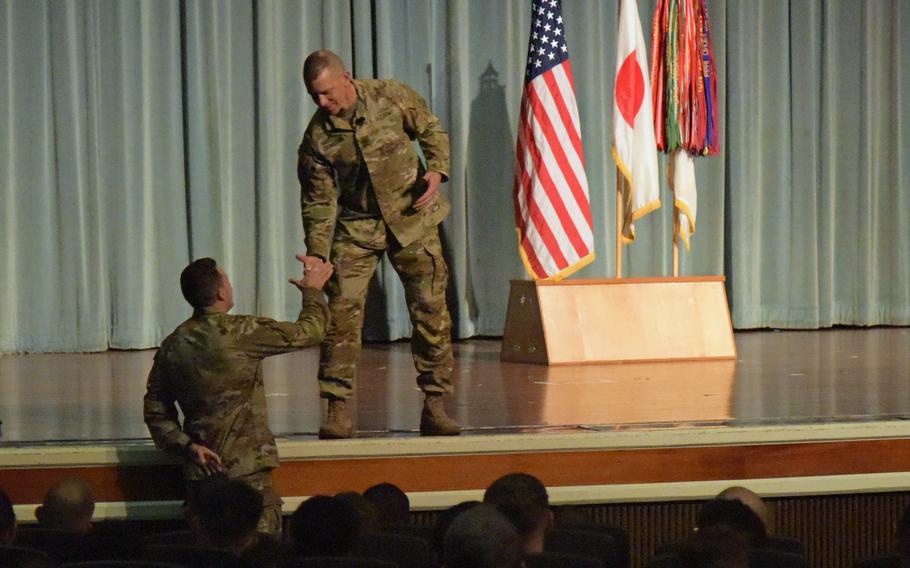 Sgt. Maj. of the Army Michael Grinston greets a soldier during a town hall meeting at Kadena Air Base, Okinawa, Monday, Nov. 21, 2022.