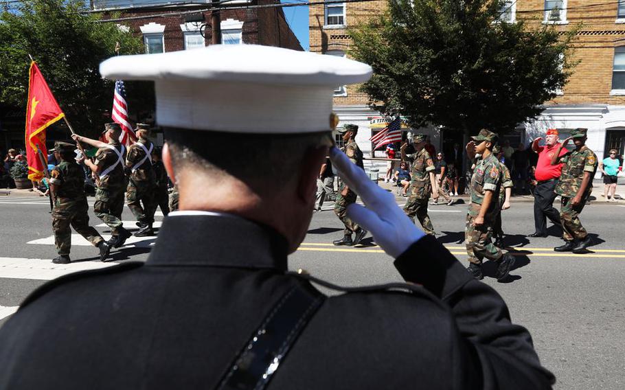 U.S. Marine Chief Warrant Officer 4 Nick D'Andrea salutes the flag during the John Basilone Parade, in Raritan, N.J., Sunday, Sept. 19, 2021