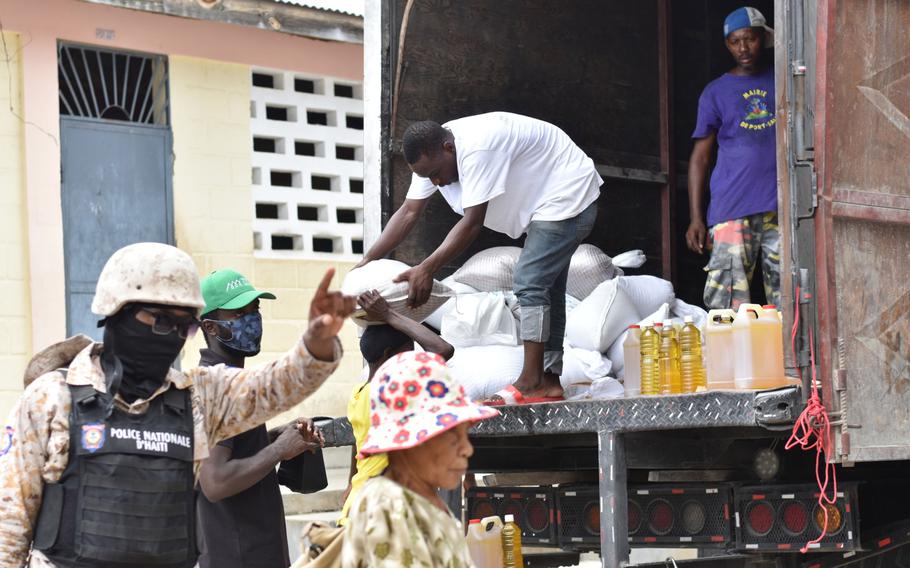 A member of the Haitian National Police guards a World Food Programme food distribution site in Port-Salut. 