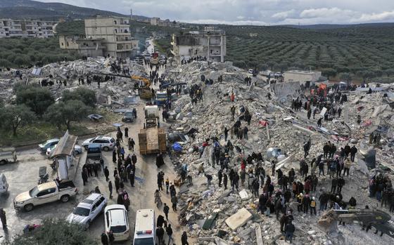 FILE - Civil defense workers and residents search through the rubble of collapsed buildings in the town of Harem near the Turkish border, Idlib province, Syria, Monday, Feb. 6, 2023. (AP Photo/Ghaith Alsayed, File)