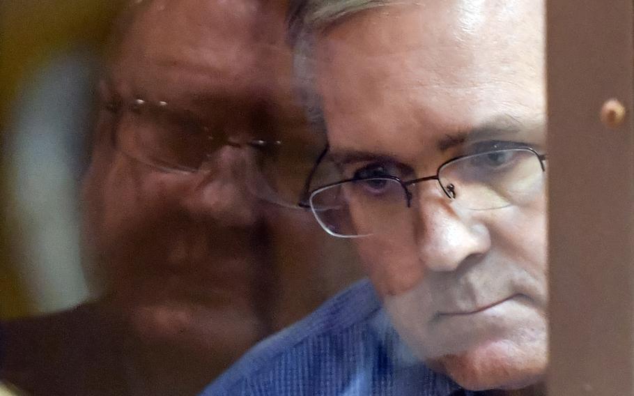 Paul Whelan, a former U.S. Marine accused of espionage and arrested in Russia, listens to his lawyers while standing inside a defendants' cage in a Moscow courtroom during a hearing on Jan. 22, 2019.