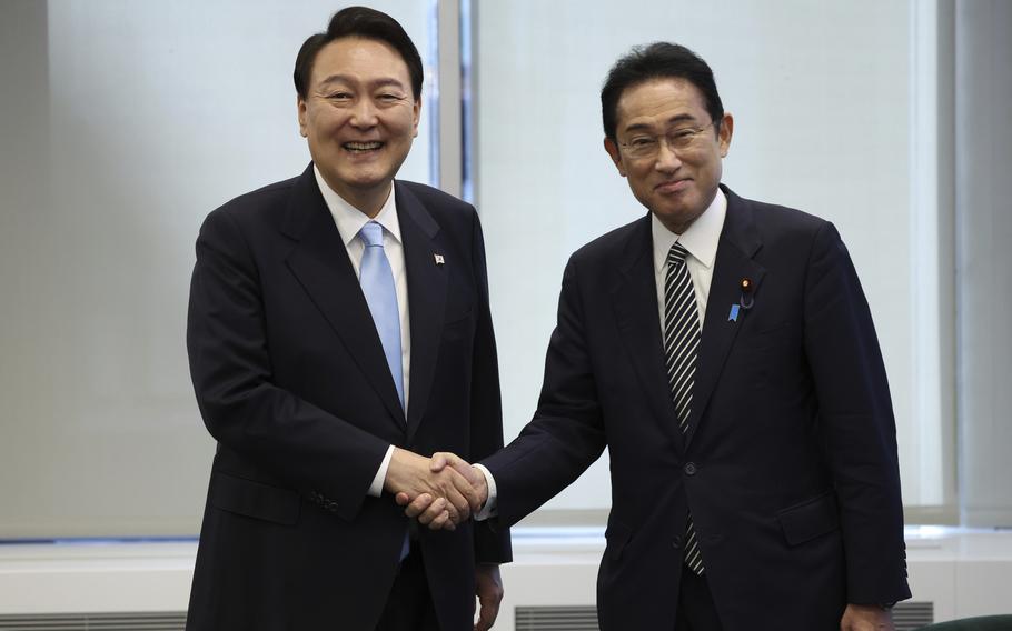 South Korean President Yoon Suk Yeol, left, shakes hands with Japanese Prime Minister Fumio Kishida before their meeting in New York, Wednesday, Sept. 21, 2022. Yoon and Kishida agreed to accelerate efforts to mend ties frayed over Japan’s past colonial rule of the Korean Peninsula as they held their countries' first summit talks in nearly three years on the sidelines of the U.N. General Assembly in New York, Seoul officials said Thursday, Sept. 22, 2022.