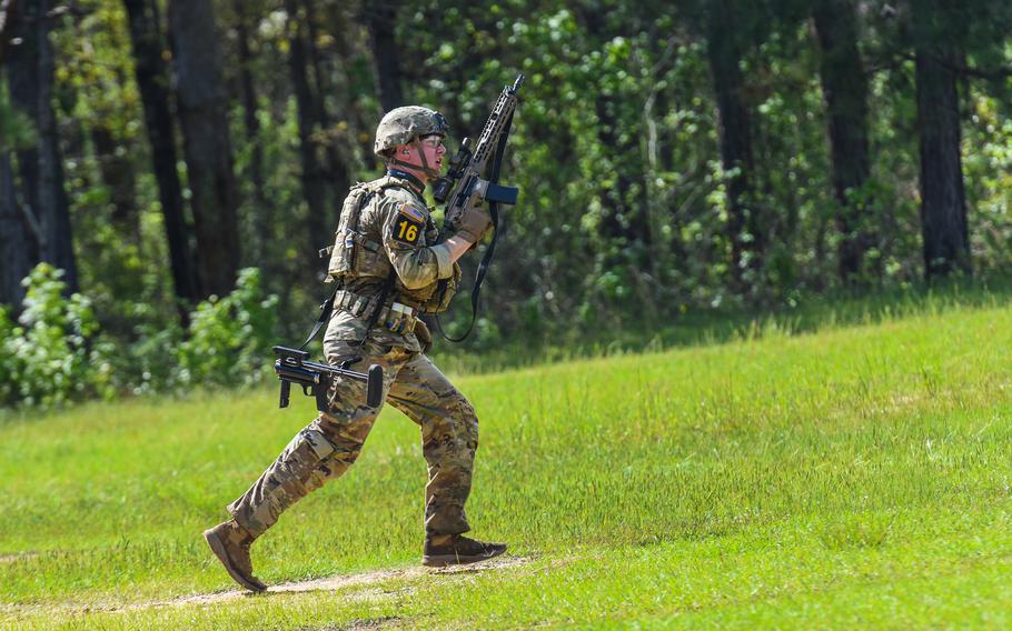 Army Spc. Nicholas Barrett of the 82nd Airborne Division moves forward during a live-fire shoot at Fort Benning, Ga., as part of the Best Ranger Competition, Friday, April 14, 2023. 