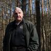 Lester Schrenk, who served as an Army B-17 ball turret gunner during World War II, stands in the forest outside Tychowo, Poland, on March 22, 2025, where he was detained as a prisoner of war 80 years earlier. 