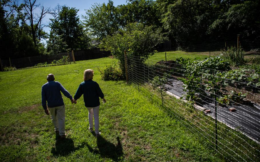 Daniel Smith, 88, and his wife, Loretta Neumann, walk past their vegetable garden in Washington, D.C., in July 2020. Smith, who was 90 when he died Oct. 19, 2022, in Washington, was one of the last remaining children of enslaved Black Americans, and a rare direct link to slavery in the United States.