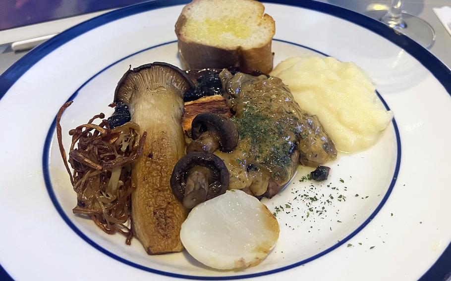 A vegetarian option aboard a recent First Airlines flight included a giant portobello mushroom, cooked to perfection and topped with a truffle sauce, mashed potatoes and garlic bread. 