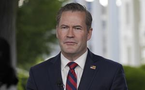 Mike Waltz in a suit and tie with a microphone near his chest.