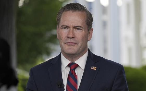 Mike Waltz in a suit and tie with a microphone near his chest.