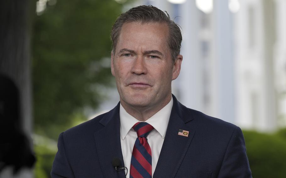 Mike Waltz in a suit and tie with a microphone near his chest.