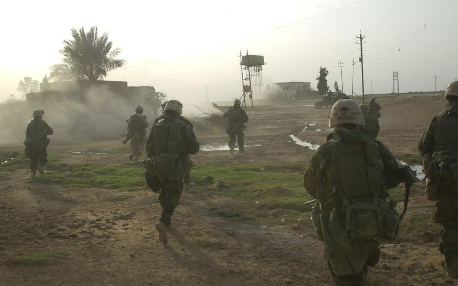 Marines from Company G rush forward toward their objective during a raid at Al Fahr to take down a Ba’ath Party headquarters building. The raid netted a cache of weapons, intelligence documents and several Baath Party leaders. 