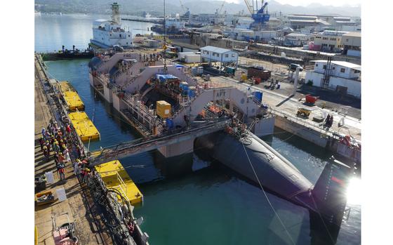 The shipyard workforce at Pearl Harbor Naval Shipyard and Intermediate Maintenance Facility prepare the Los Angeles-class fast-attack submarine USS Chicago (SSN 721) to undock from Dry Dock 3 in September 2018.