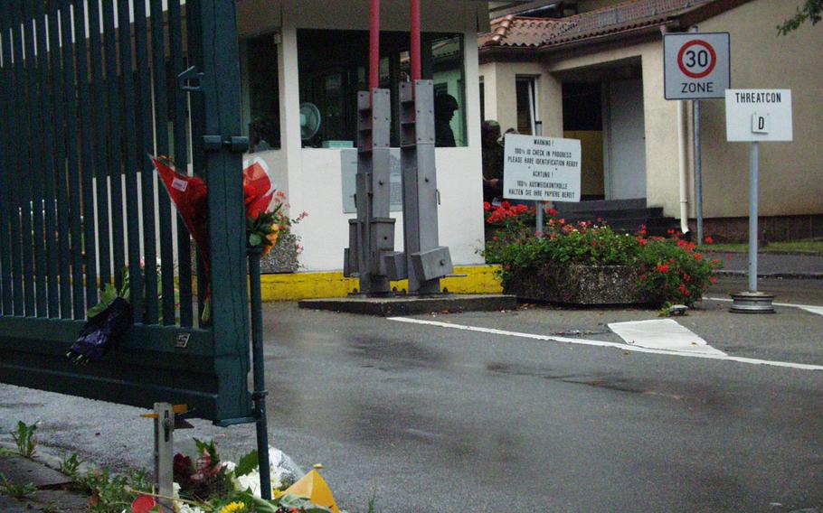 Residents of Stuttgart, Germany, place flowers and a prayer candle outside the gate of Kelley Barracks on Sept. 12, 2001. Following the 9/11 attacks, security was tightened at U.S. bases worldwide, and many of the measures are still in place today.