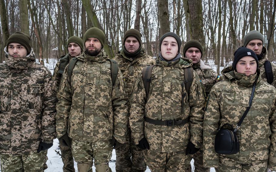 Students who are also being trained as reservists observe the training of reserve officers in the 130th battalion of the Ukrainian Territorial Defense Forces in Kyiv, Ukraine, on Jan. 22. The Territorial Defense Forces are part of the Ukrainian armed forces and include citizen volunteers. 