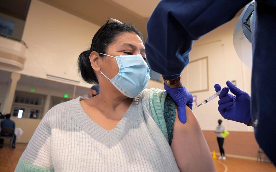 Lesbia Ruiz receives her vaccination from Theresa Williams, a registered nurse, during a coronavirus vaccination drive for the Hispanic population at Sacred Heart Church in Highlandtown, a vaccination site partnering with Johns Hopkins Hospital, on March 24, 2021. 