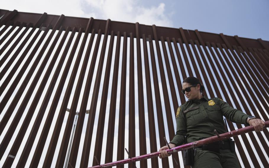 A U.S. Border Patrol agent works along the wall separating the United States and Mexico in San Diego. MUST CREDIT: Photo for The Washington Post by Eric Thayer