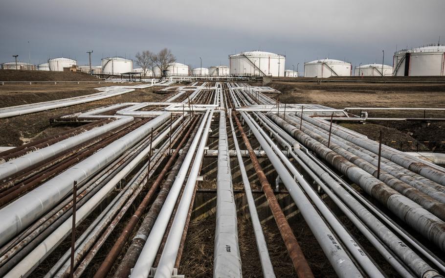 Oil transportation pipes and storage tanks stand in the Duna oil refinery, operated by MOL Hungarian Oil & Gas, in Szazhalombatta, Hungary, on Feb. 13, 2019. 