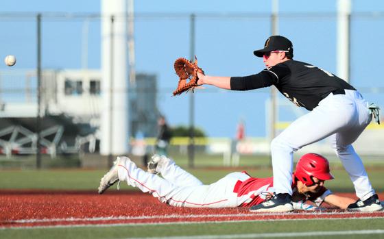 Kinnick's Shobu Deeter dives back to first base ahead of the pickoff throw to ASIJ's Leo Linsley.