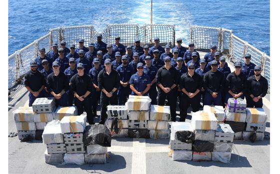 The crew of U.S. Coast Guard Cutter Reliance (WMEC 615) poses for a photo in front of approximately $52 million in illicit narcotics on the cutter’s flight deck in the Eastern Pacific Ocean, Feb. 13, 2024. Patrolling in support of Joint Interagency Task Force-South, the Reliance crew stopped two drug trafficking ventures, detaining six suspected traffickers and preventing nearly 4,000 pounds of cocaine and 5,400 pounds of marijuana, worth more than $57 million, from entering the United States. (U.S. Coast Guard photo courtesy of Reliance)
