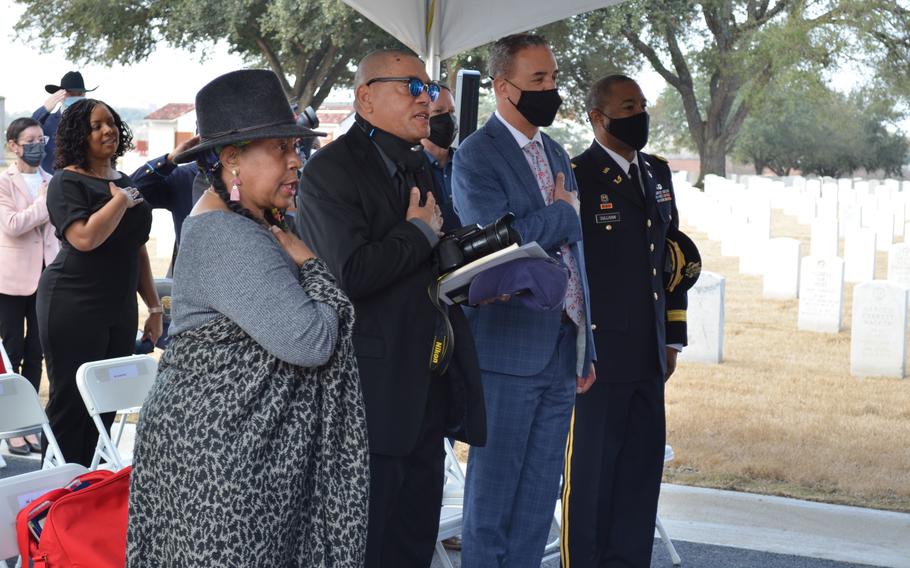 Angela Holder and Charles Anderson, far left, recite the pledge of allegiance during a ceremony Tuesday to unveil a sign about the Houston Riots of 1917. The two are descendants of two of the 19 soldiers hanged for mutiny following the riots.
