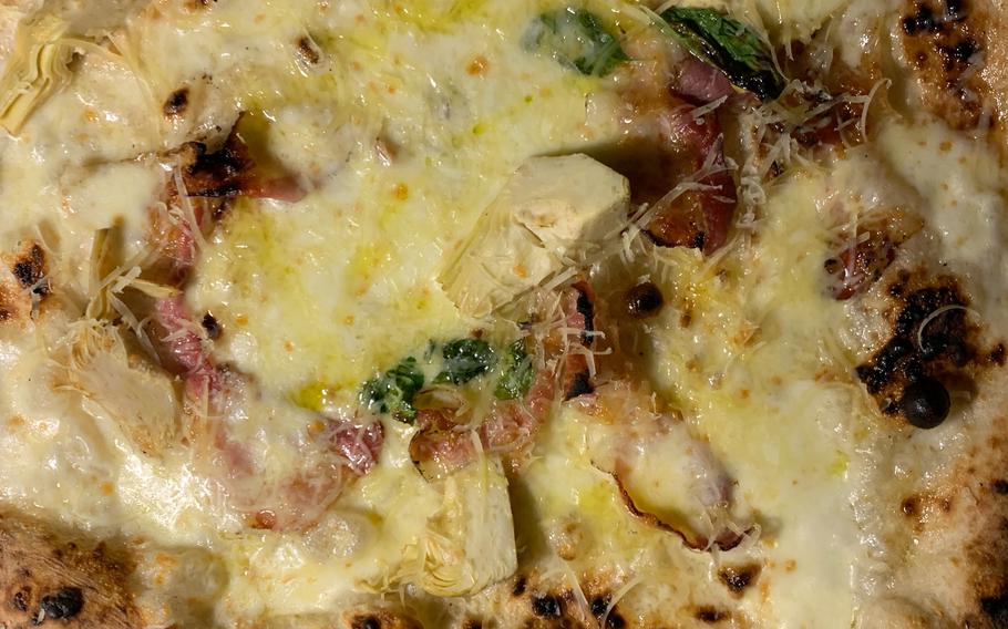 The carciofi con pancetta at Pizzeria Salvo in Naples, Italy, features artichokes, pancetta (bacon), fior di latte cheese, grated ragusano cheese, extra virgin olive oil and basil. 