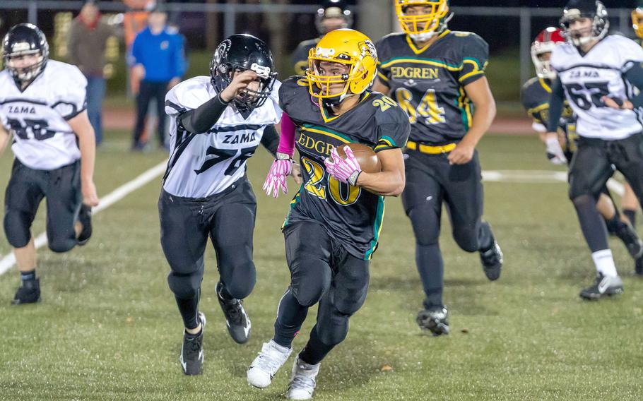 Edgren's Douglass Tackney tries to outrun Zama's Kainoah Venn.