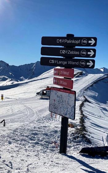 The pole and signage at Ischgl ski resort in Austria that Kiefer Jones crashed into while snowboarding at nearly 50 mph on Jan. 14, 2022. The rescue helicopter that airlifted Jones to a hospital in Innsbruck is in the background. Jones suffered a traumatic brain injury and broke 21 bones in his body. He is recovering at his home near Aviano Air Base, Italy. 