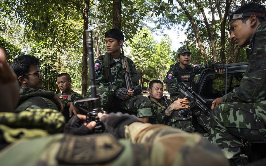 Fighters of Brigade 7 of the Karen National Liberation Army rest on the back of a pickup truck after returning from the front line in KNU headquarters in October. 