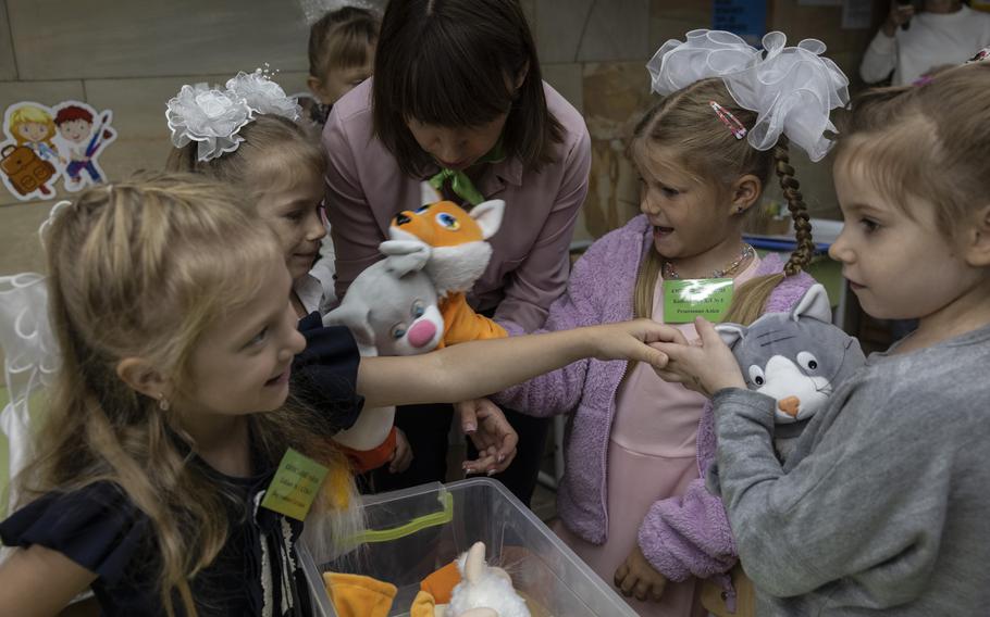 First graders play with puppets in a classroom on the first day of school held in the underground metro station in Kharkiv, Ukraine, on Monday, Sept. 4, 2023.