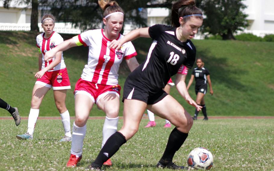 Humphreys' Claire Anderson keeps the ball away from Nile C. Kinnick's Lucy Mock during Tuesday's Division I girls soccer quarterfinal. The Red Devils won 3-0.