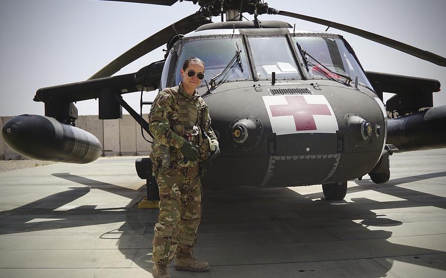 Staff Sgt. Brianna Pritchard, an Army National Guard UH-60 Black Hawk helicopter mechanic from Anchorage, Alaska, poses in front of a Task Force Phoenix UH-60 Black Hawk medical evacuation helicopter at al Asad Air Base, Iraq. 