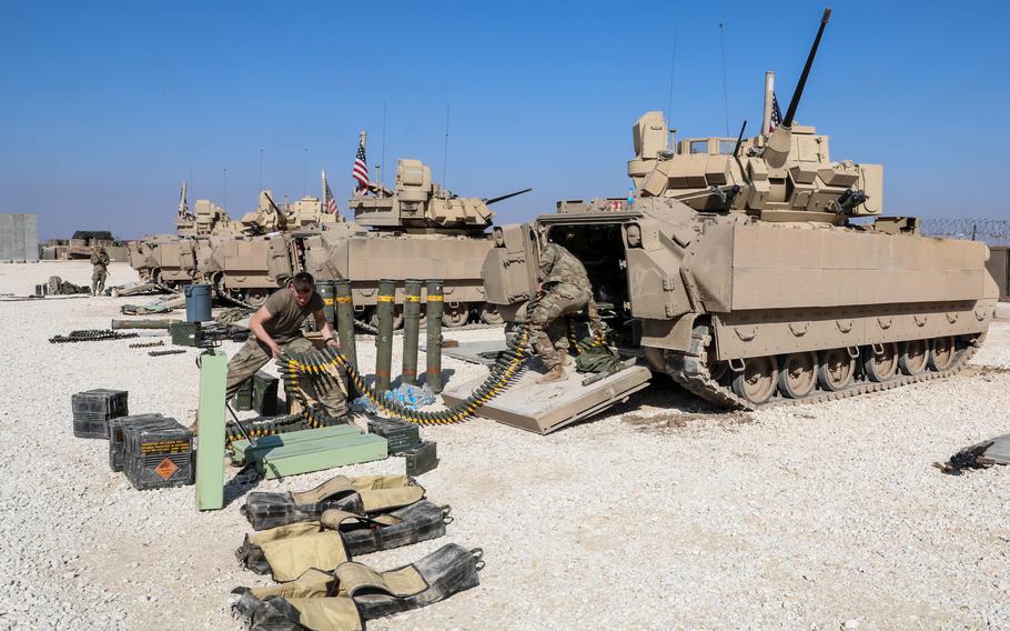 U.S. soldiers from the 2nd Platoon, Alpha Company, 1/163rd Combined Arms Battalion, ready their M2A3 Bradley Fighting Vehicle in northeast Syria, Feb. 1, 2022. An explosion that wounded four U.S. service members came from deliberately placed explosive charges in an ammunition storage room and a shower area, not from a rocket or mortar attack, military officials said Thursday.
