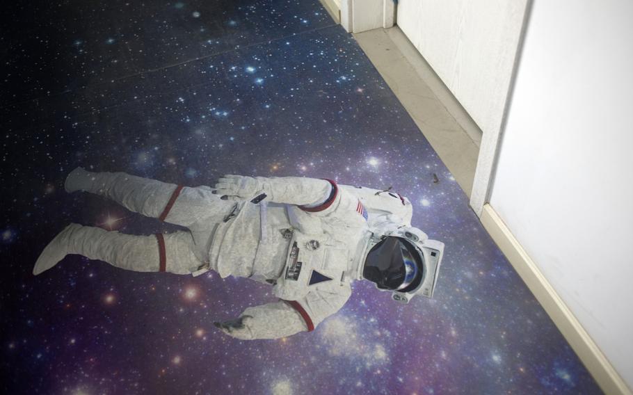 Flooring featuring an image of an astronaut is seen inside a corridor of a building at the Chinese Academy of Sciences in Beijing on Nov. 14, 2018. 