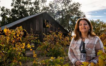 Paskett Vineyards & Winery owner Lorraine Paskett is photographed with a bottle of Cabrona, a Bordeaux-style blend, at her vineyards Oct. 26, 2021, near Lodi, Calif. “Part of it sort of honors my mom, but it also honors my friends,” she said of the label. 
