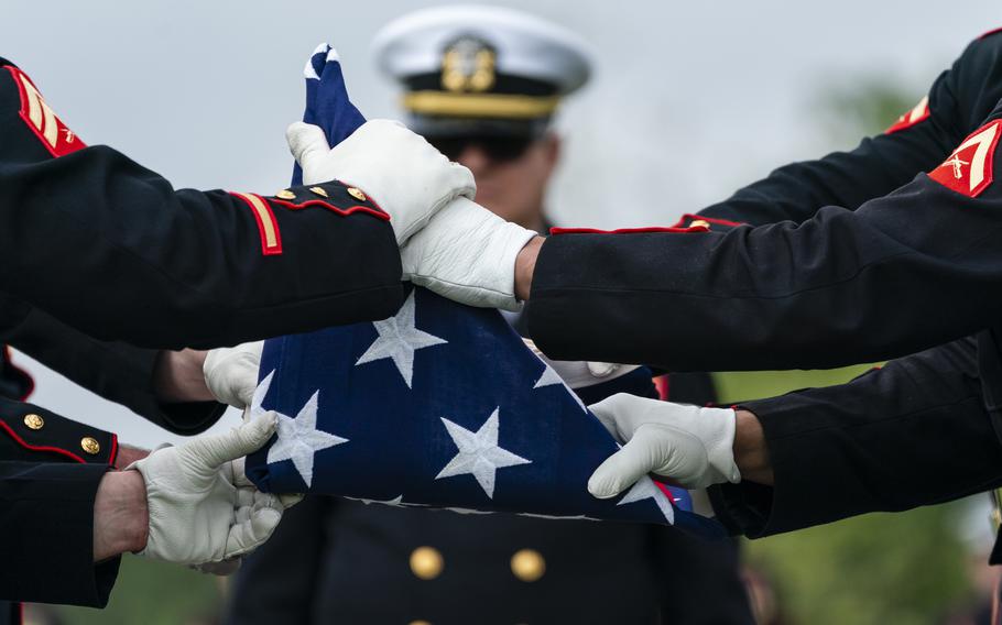 Marines fold a flag during a service for Pfc. Lawrence Earl Garrison at Arlington National Cemetery on Thursday. Garrison was killed during the Battle of Tarawa in the Pacific on Nov. 20, 1943. DNA sequencing led to the identification of his remains nearly 80 years later.