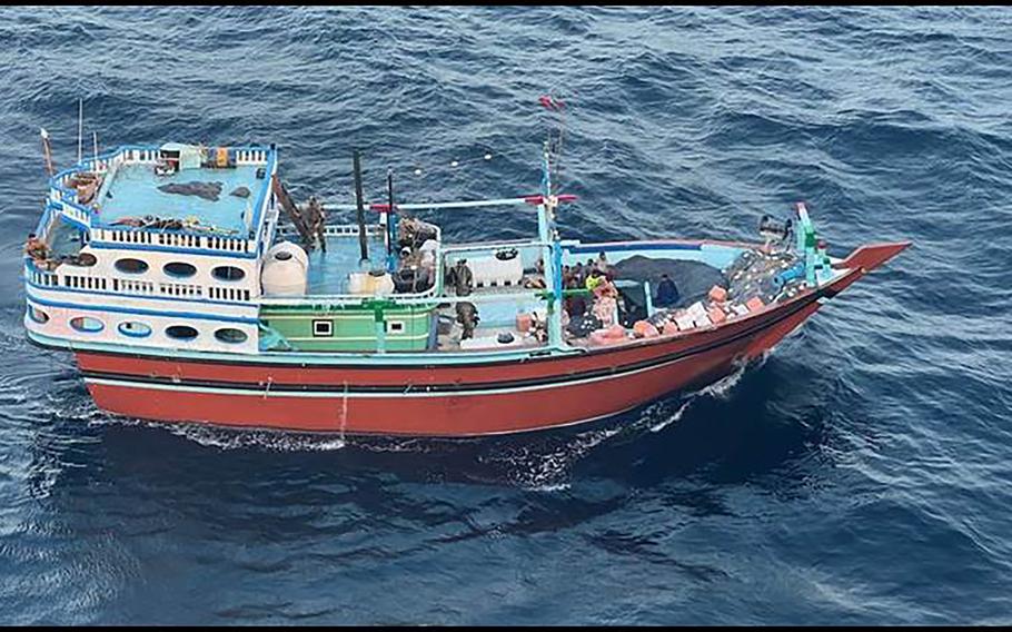 A small boat floats in the ocean.
