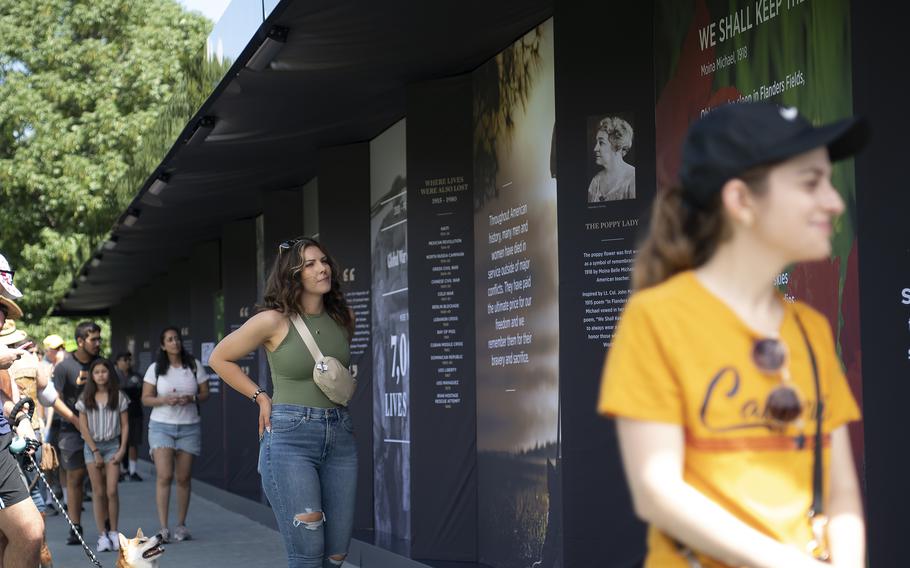 Visitors walk through the USAA Poppy Wall of Honor on Saturday, May 28, 2022, in Washington D.C.