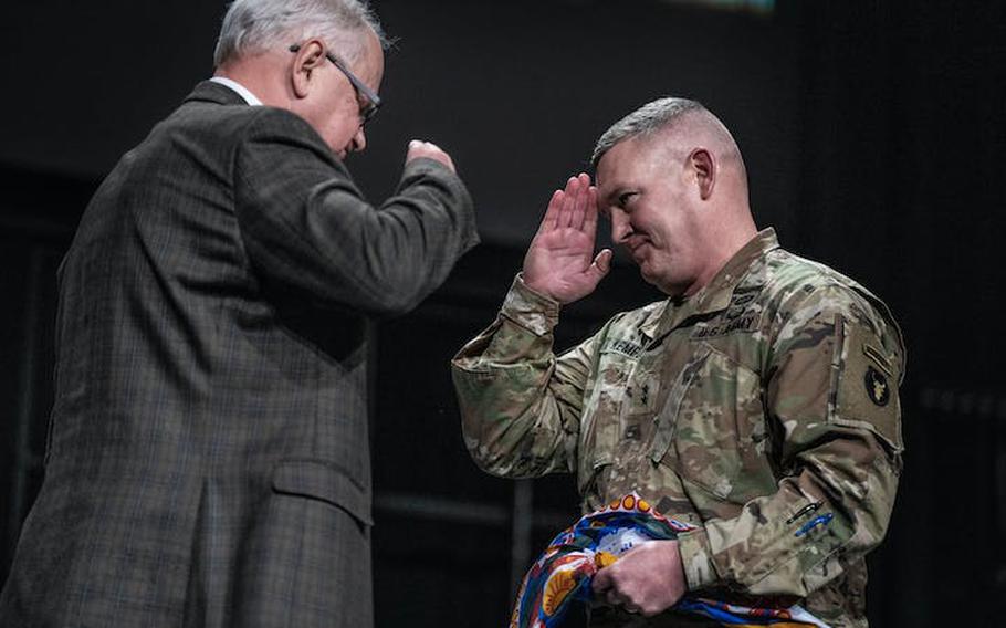 Minnesota Gov. Tim Walz, left, presents the Minnesota state flag to Maj. Gen. Charles Kemper during deployment ceremonies for 550 members of the Minnesota National Guard’s 34th Infantry Division Red Bulls at Grace Church on Thursday, Feb. 1, 2024. They’re heading to Kuwait in one of the Minnesota National Guard’s largest deployments since the end of the Iraq War.